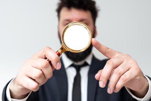 Man Having Magnifying Glass To Point Important Informations.