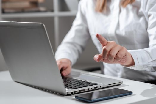 Woman Typing Updates On Lap Top And Pointing New Ideas With One Finger.