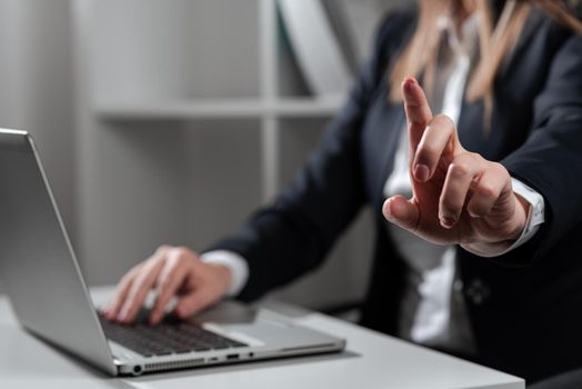 Woman Typing Updates On Lap Top And Pointing New Ideas With One Finger.