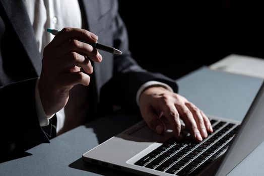 Man Typing Important Data Into Laptop And Pointing New Idea With Pen.