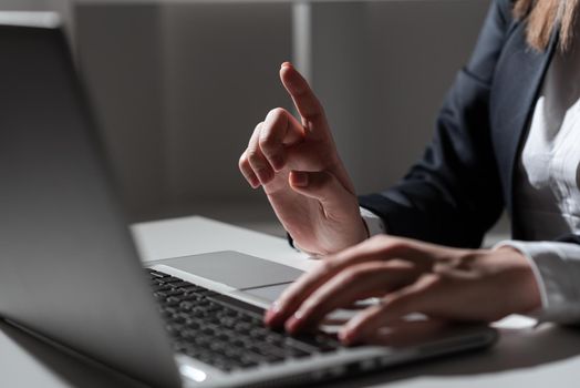 Woman Typing Updates On Lap Top And Pointing New Ideas With One Finger.