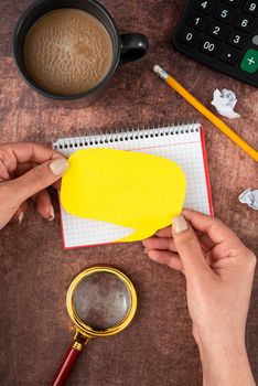 Hands Of Woman With Thought Bubble, Coffee Cup And Stationery Over Wood.