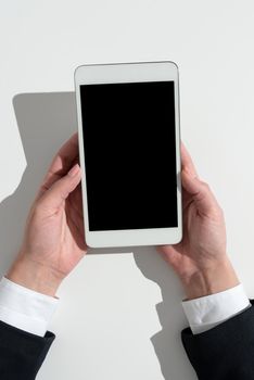 Businesswoman Holding Cellphone And Presenting Important Informations.