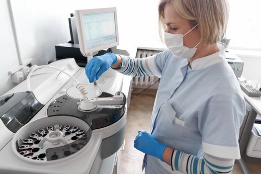 Female doctor using a centrifuge in a hospital