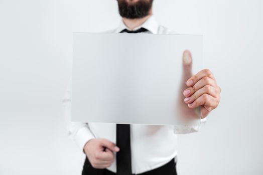 Man Holding Paper Presenting Marketing Strategies For Development.