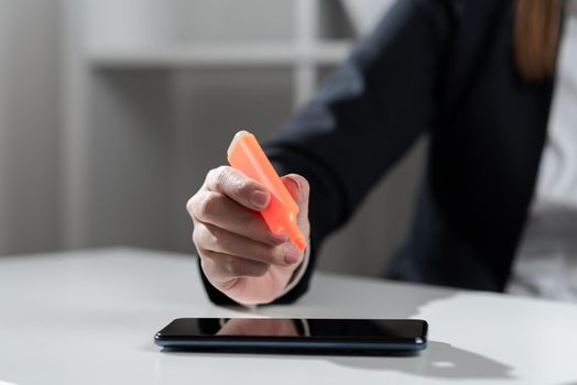 Businesswoman Pointing With Marker On Important Messages On Desk With Phone