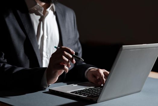 Man Typing Important Data Into Laptop And Pointing New Idea With Pen.