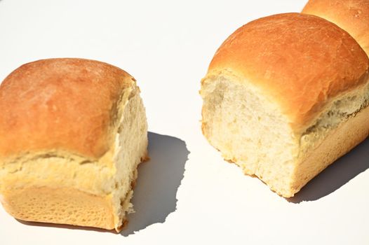 Close-up. Food composition of a fresh baked whole grain buns on a white background with copy ad space for advertising text.