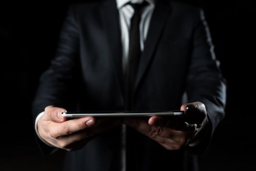 Businessman Holding Tablet With Both Hands And Presenting Important Data