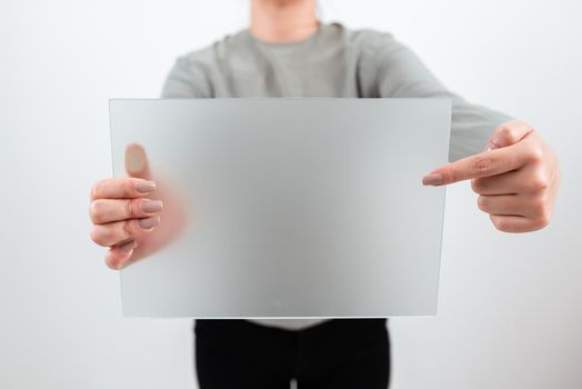 Woman Holding And Pointing At Placard While Promoting The Business.