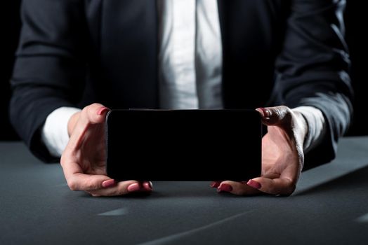 Businesswoman Holding Phone And Presenting Important Informations On Screen