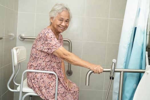 Asian senior or elderly old lady woman patient use toilet bathroom handle security in nursing hospital ward, healthy strong medical concept.