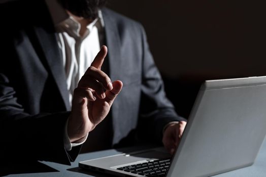 Man Typing Important Data Into Laptop And Pointing New Idea With One Finger