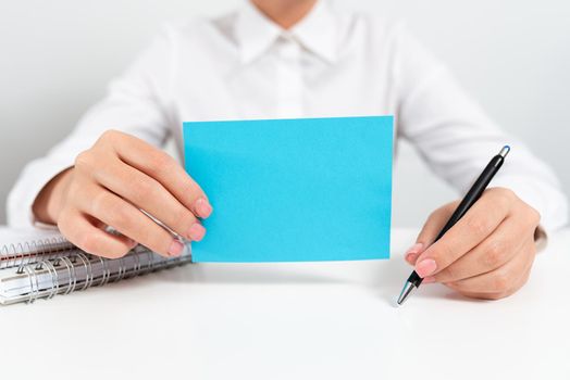 Businesswoman Holding Note With Important Message And Pointing With Pen.