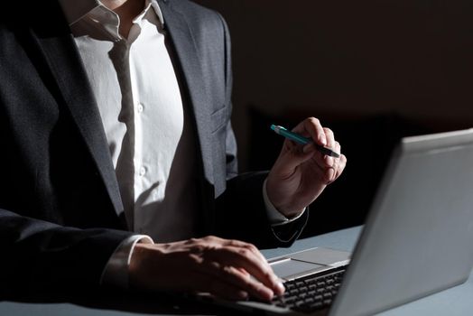 Man Typing Important Data Into Laptop And Pointing New Idea With Pen.