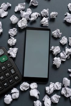 Phone Screen With New Idea On It Surrounded With Paper Wraps And Calculator