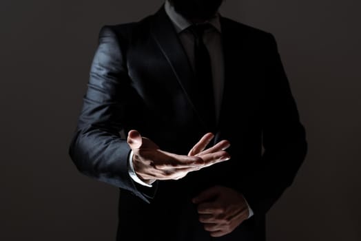 Businessman In Suit Holding Important Infortmations Over One Hand.