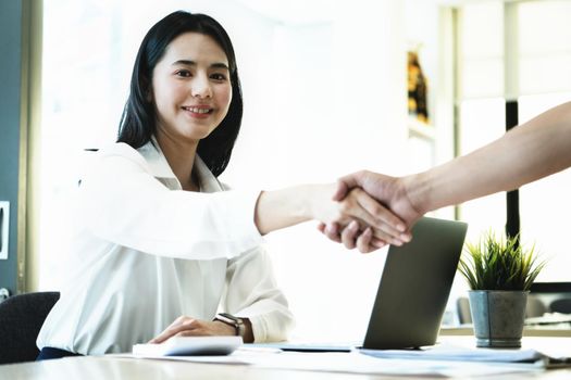 focus on smiling woman, Young businesswoman collaborate with partners to increase their business investment network for Plans to improve quality next month in their office. agreement concept