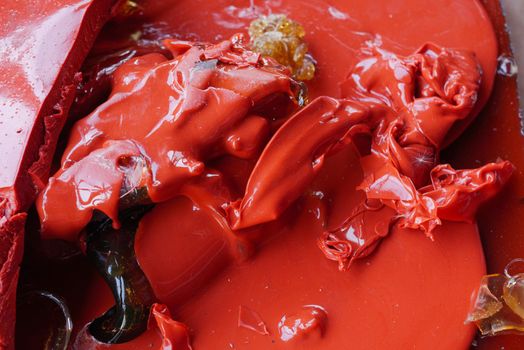 The concept of gelatin production. Melted red gelatin close-up. Wastes from the production of gelatin.