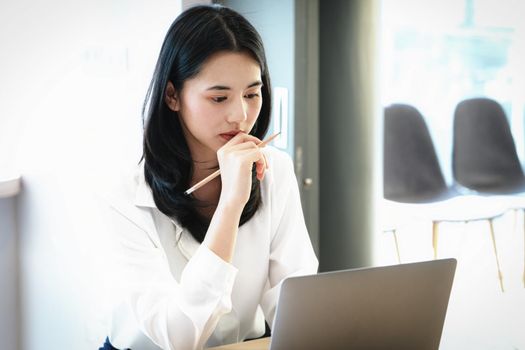 Female employees are working at home through computers to maintain social distancing to reduce the spread of coronavirus