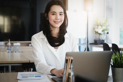 Female employees are working at home through computers to maintain social distancing to reduce the spread of coronavirus