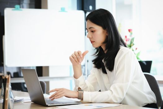 Female employees are working at home through computers to maintain social distancing to reduce the spread of coronavirus