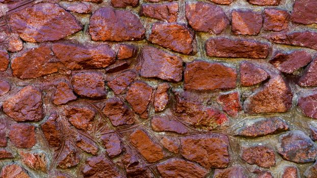 Close-up view of rough weathered stone wall texture, full frame background