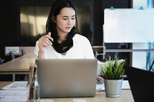 Female employees are working at home through computers to maintain social distancing to reduce the spread of coronavirus