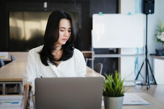 new normal, a businesswoman uses a computer to work for a company Via the internet on your desk at home