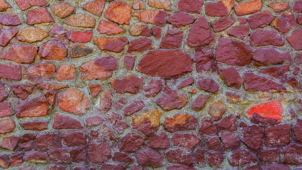 Abstract background of a multi-colored stone wall