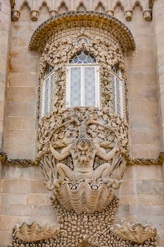 A round and ornate bay window on the facade of the Palacio Nacional da Pena above the town of Sintra, Portugal