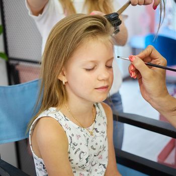 Children make up. Glitter makeup. Sparkles on cheek