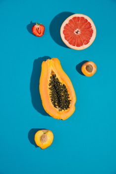 tropical summer fruits on blue background. creative arrangement