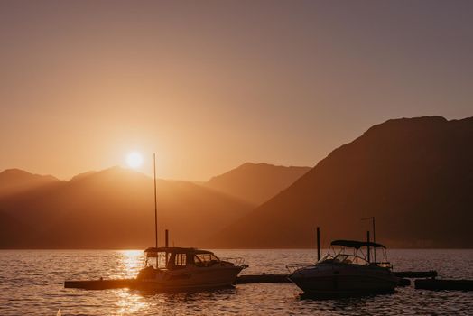 Silhouette of sailing yachts in the sea on beautiful sunset backgroung