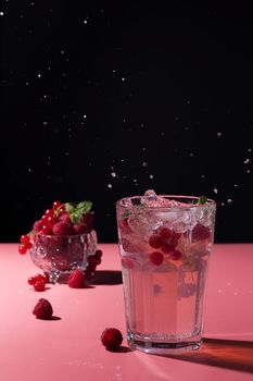 Splash of berry cocktail on pink background