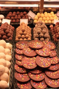 Chocolate balls and pralines in various flavors and shapes at a market in Barcelona, Spain