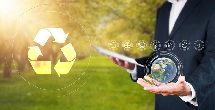 Environment concept Business man hold and show global with eco icon. business man using tablet to analyze environmental conservation industry Environmental protection business for a sustainable future