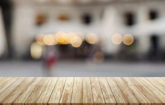 Empty wooden table on abstract blurred terrace background, assembly, product display.