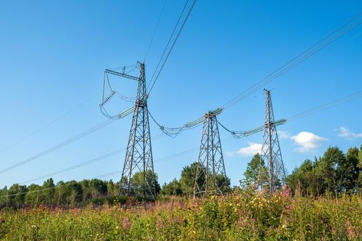 View of fragment of power line as component of large electrical networks and system of power equipment. Electricity transmission, electric current. Energy supply of regions. Selective focus.