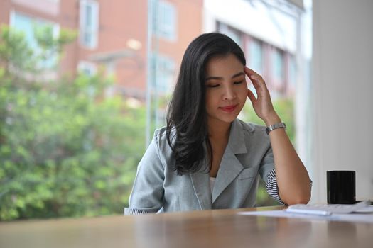 Frustrated young businesswoman having problems at work, feeling dissatisfied with financial report.