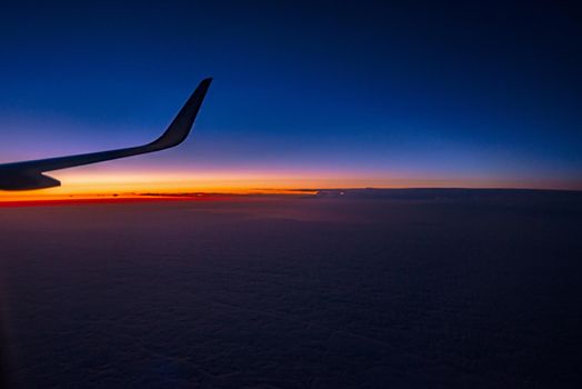 View from the plane on a beautiful orange sunset