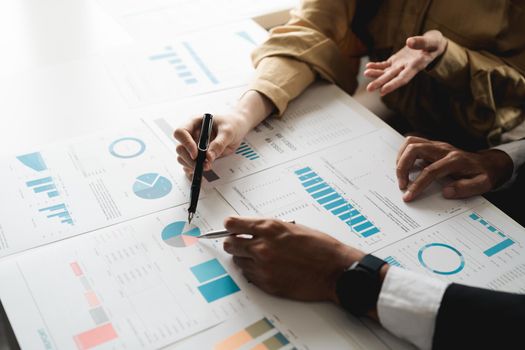 Business People Meeting to discuss and brainstorming the financial report paperwork in home office. Financial advisor teamwork and accounting concept.