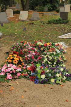 Fresh flowers on a grave after a funeral