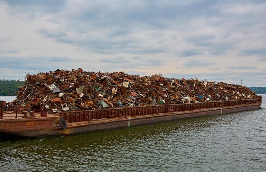 Transportation industry. Ship barge transports scrap metal and sand with gravel.