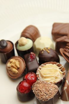 Luxury belgium chocolate pralines, decorated with fruits and nuts