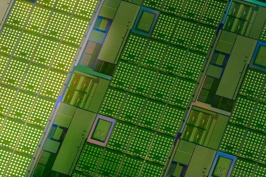 Silicon monocrystalline wafer with microchips after photolithography etching manufacturing used in fabrication of electronic integrated circuits. Full-frame high-tech macro background.