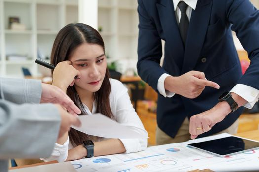 The portrait of an Asian female worker was warned by her supervisor as the profitability sales did not meet the planned targets.