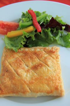 Goat cheese in puff pastry with lettuce, French appetizer