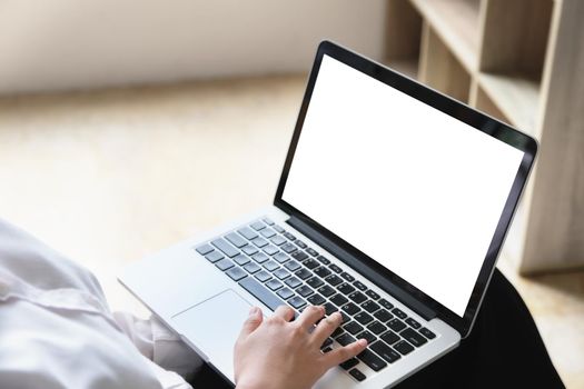 freelance concept, man using computers laptop on wooden desk blur background. Laptop computer with blank screen and can be add your texts or others on screen