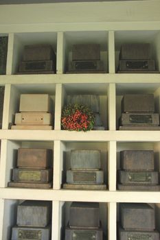 Urns with ashes in a columbarium wall